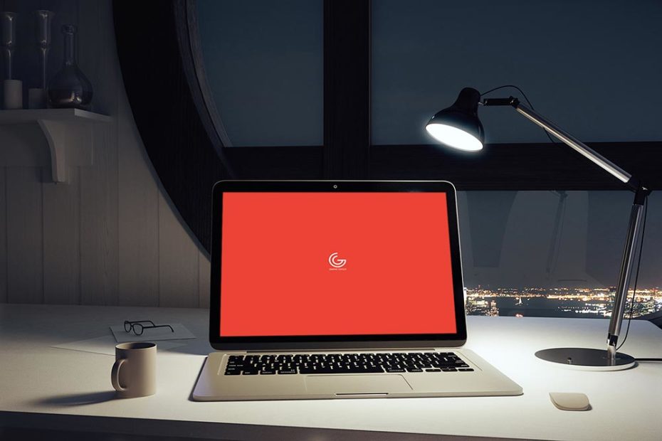 Mockup of a laptop on a table with lamp