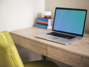 Free MacBook on Desk Mockup PSD